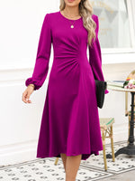Woman wearing a purple dress in an indoor setting