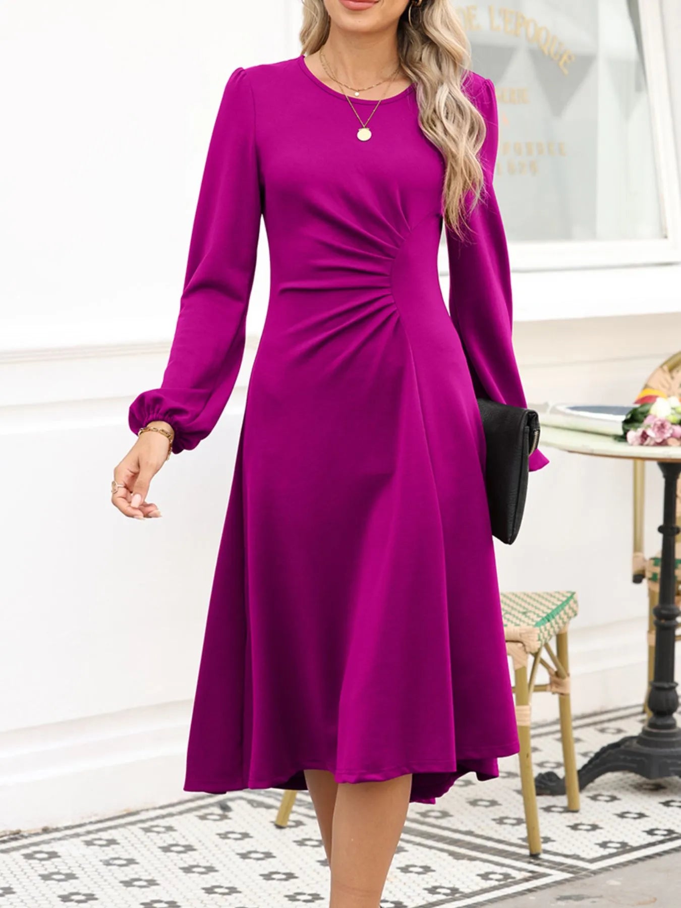 Woman wearing a purple dress in an indoor setting