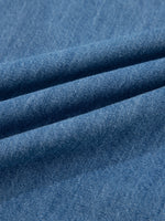 Close-up of blue denim fabric with visible texture