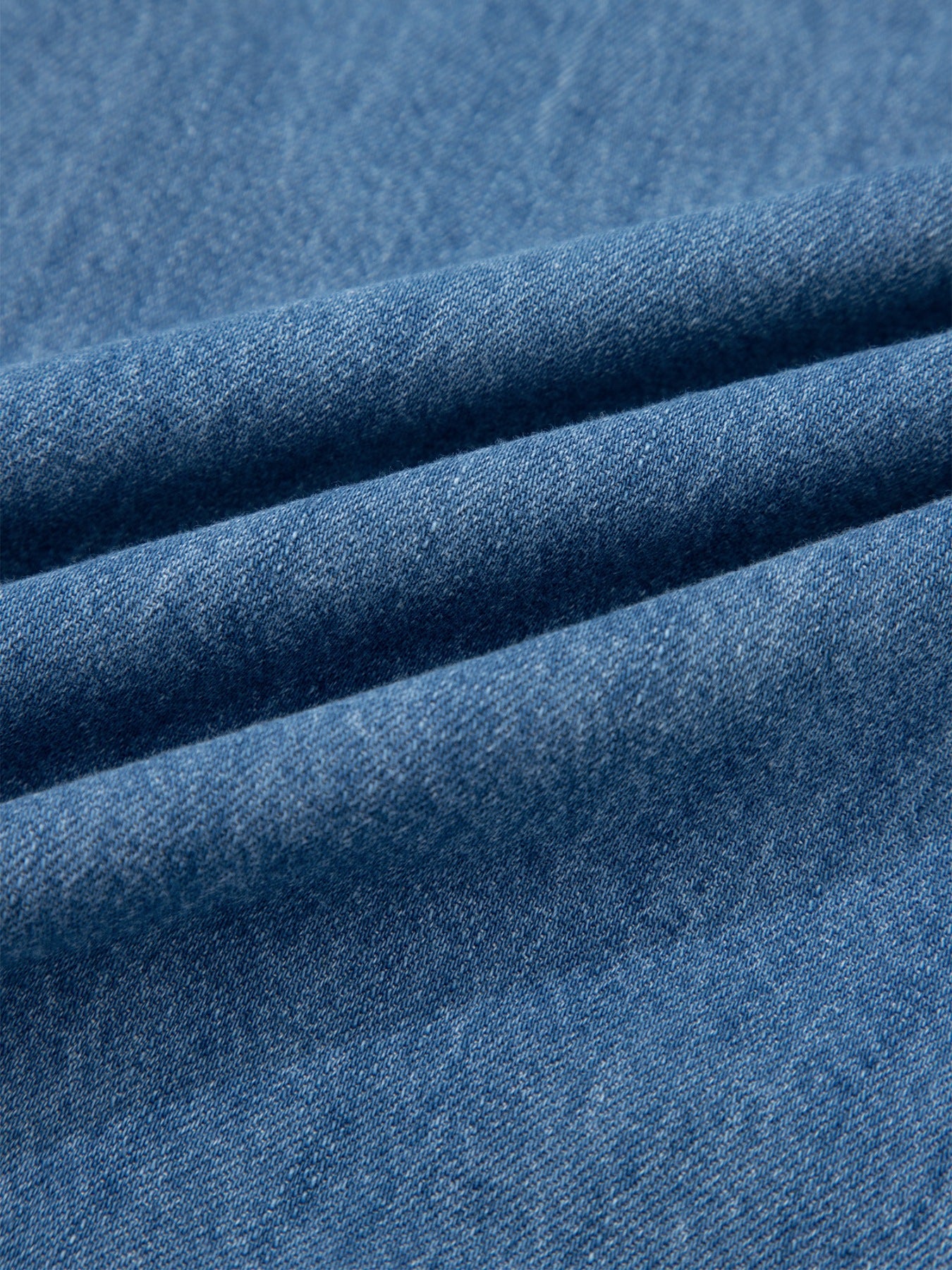 Close-up of blue denim fabric with visible texture