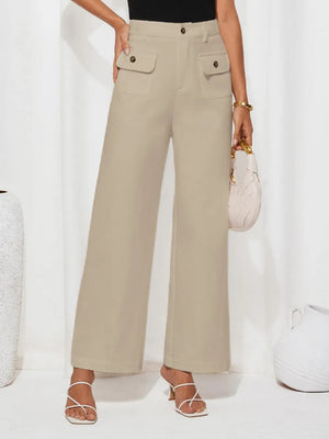 Person wearing beige high-waisted pants on a white background