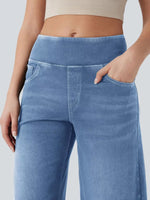 Blue jeans worn by a person on a plain background