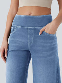 Blue jeans worn by a person on a plain background