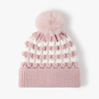 Pink knit beanie with white pom-poms on a white background