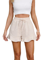 Beige shorts worn by a person on a white background