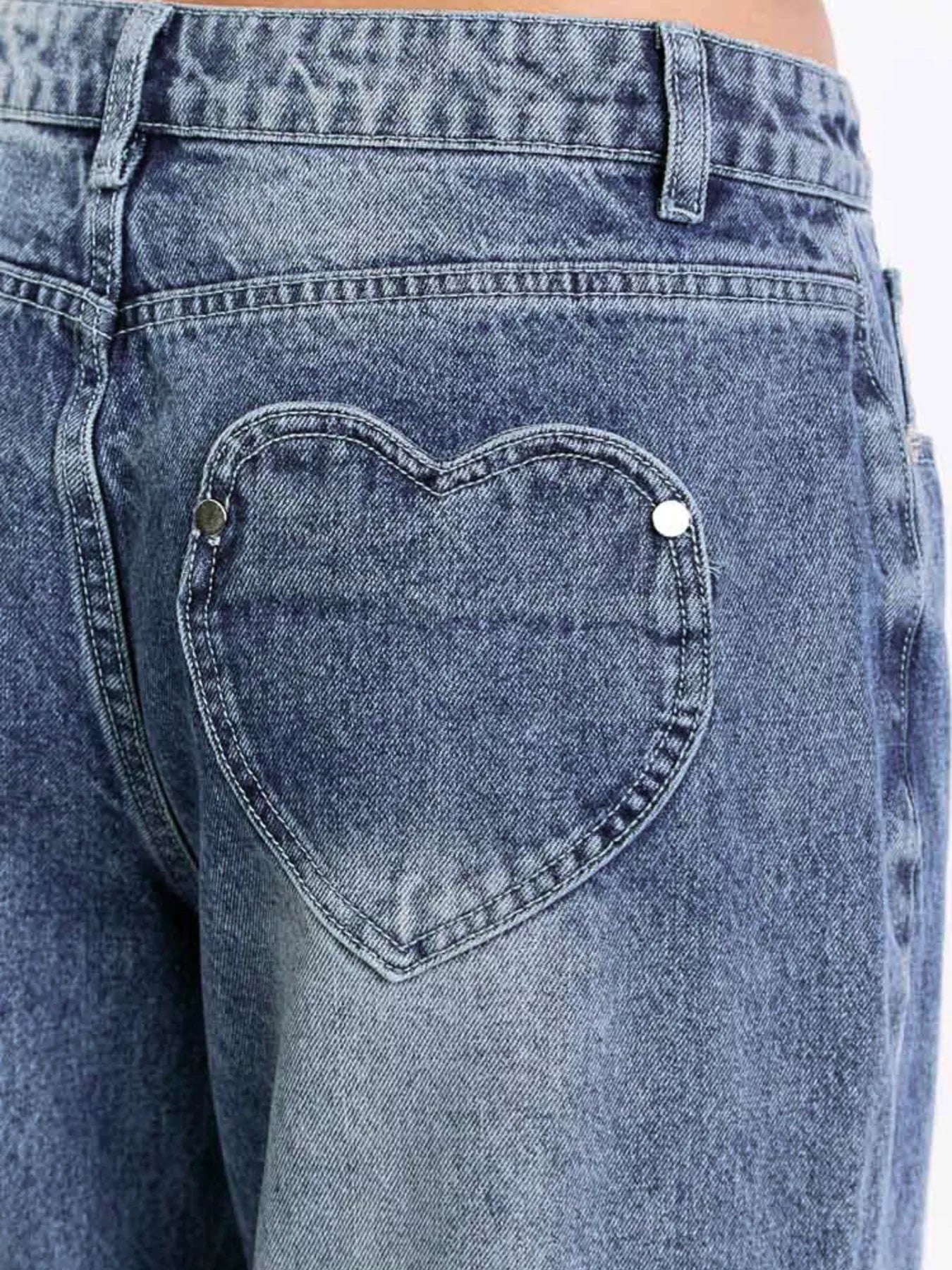 Blue denim jeans with a heart-shaped pocket design.