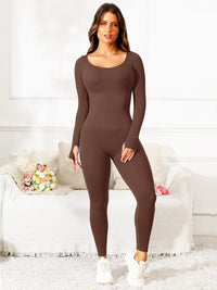 Woman wearing a brown bodysuit in a living room setting