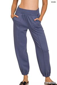 Blue pants worn by a person on a white background