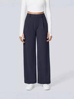Person wearing navy wide-leg pants on a white background