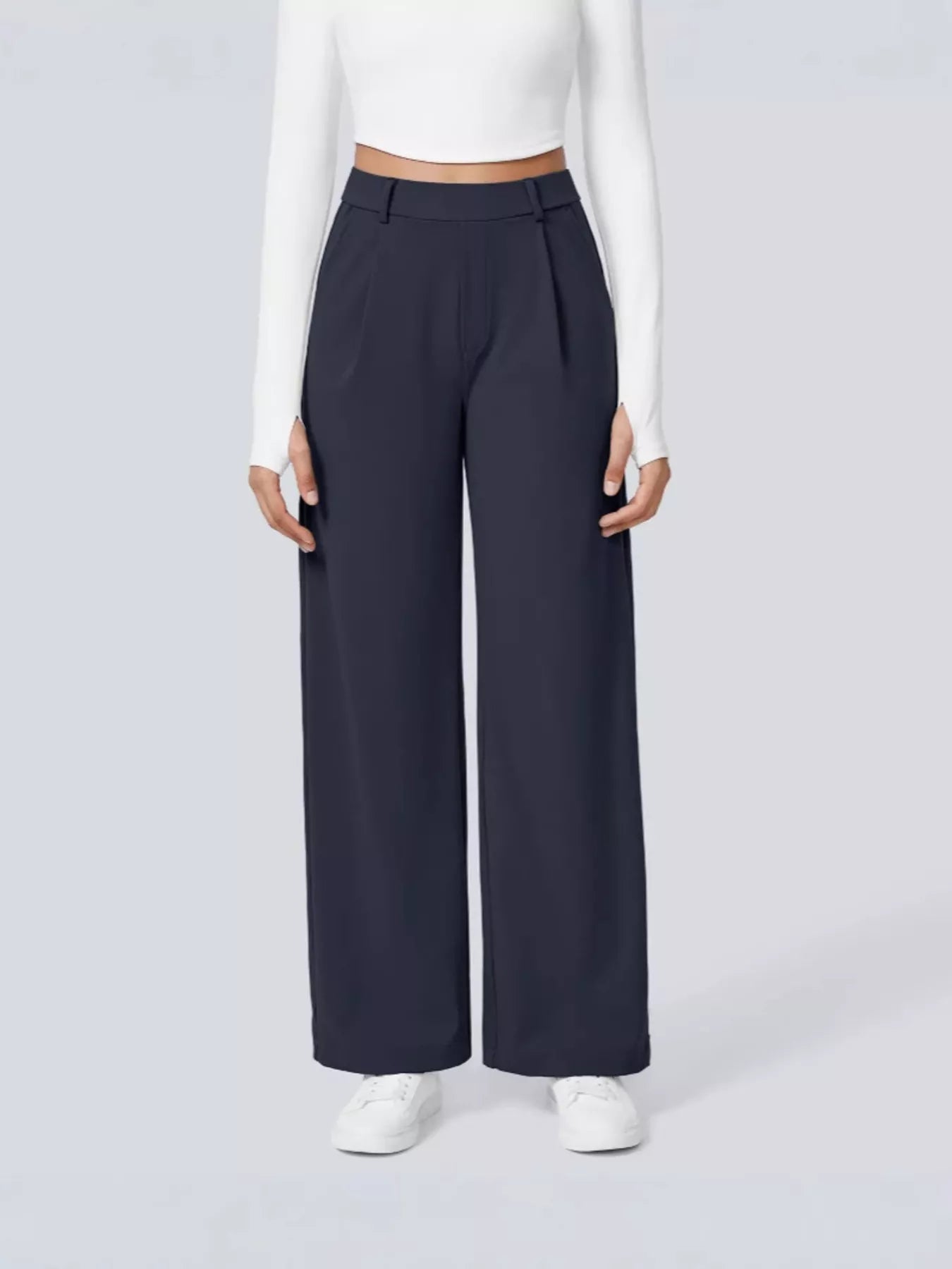 Person wearing navy wide-leg pants on a white background