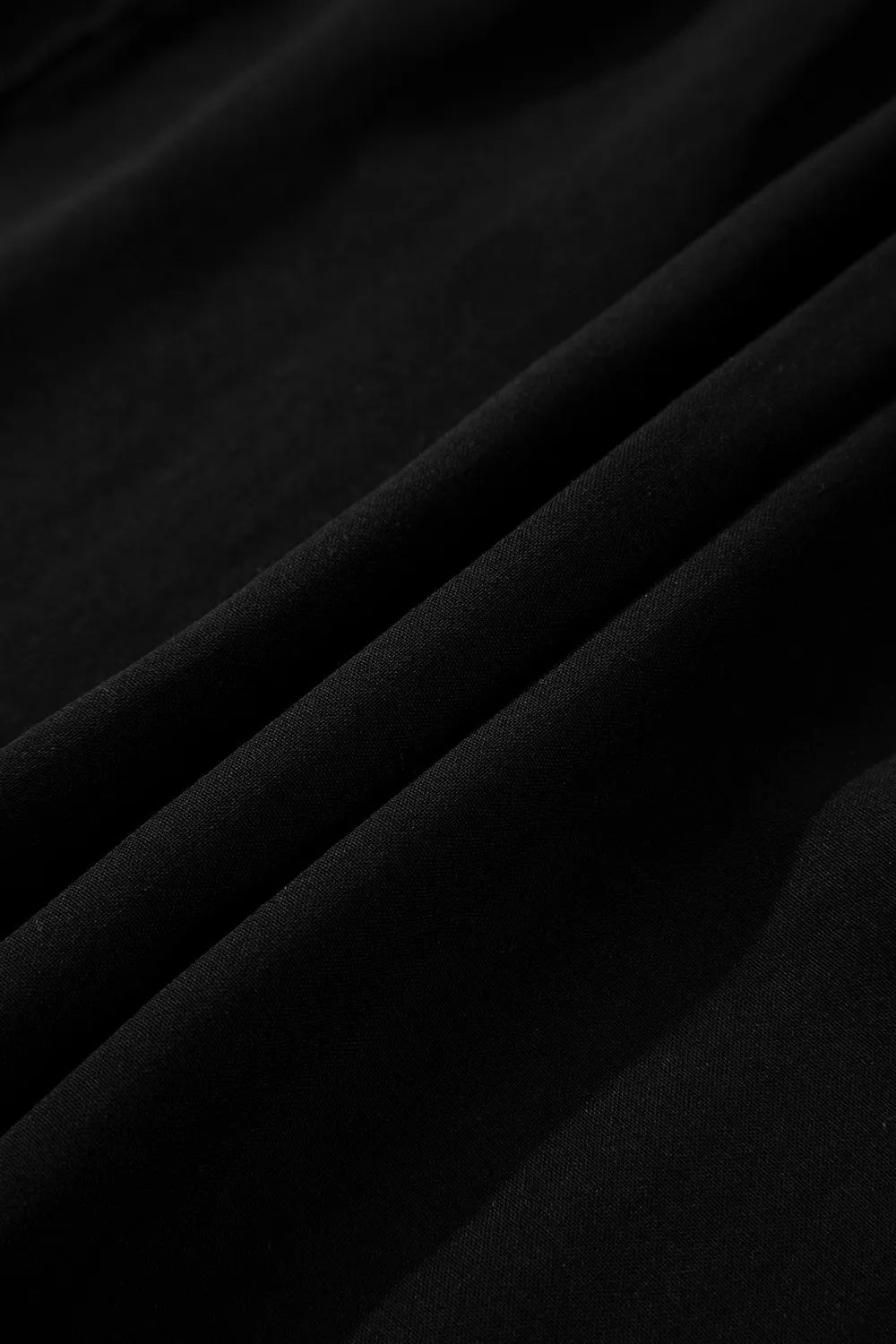Close-up of black fabric with folds