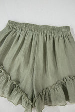 Green ruffled shorts on a white background