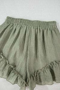 Green ruffled shorts on a white background