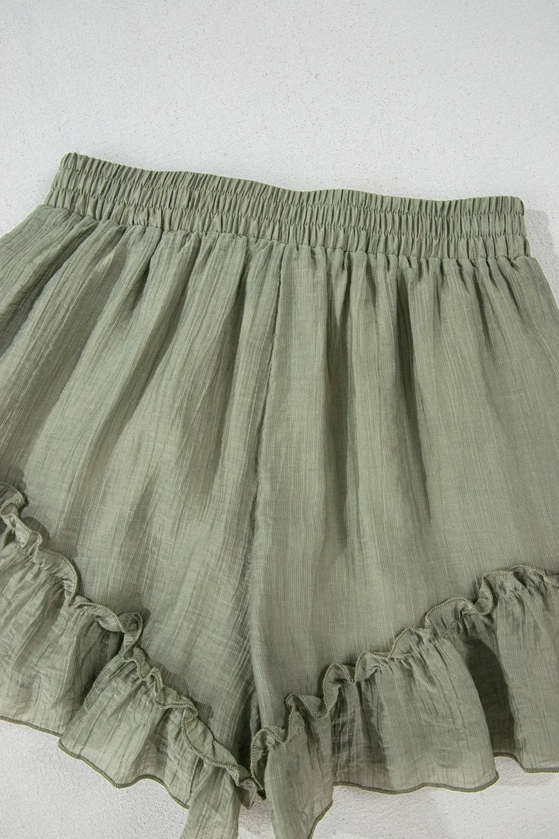 Green ruffled shorts on a white background