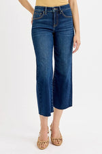 Blue jeans worn by a person on a white background