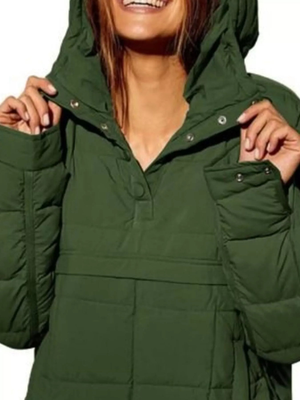 Green puffer jacket worn by a person on a white background