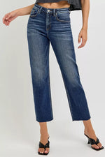 Blue jeans worn by a person on a white background