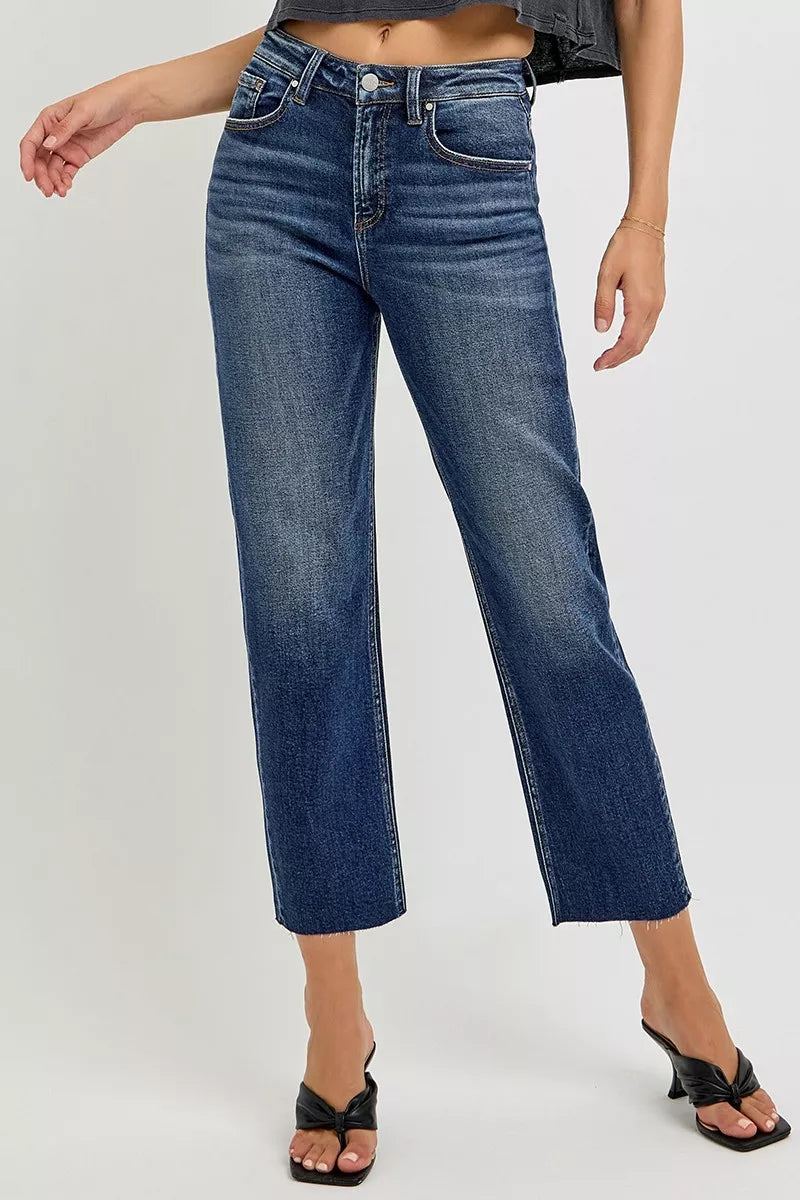 Blue jeans worn by a person on a white background