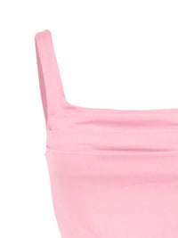 Close-up of a pink garment with thin straps on a white background