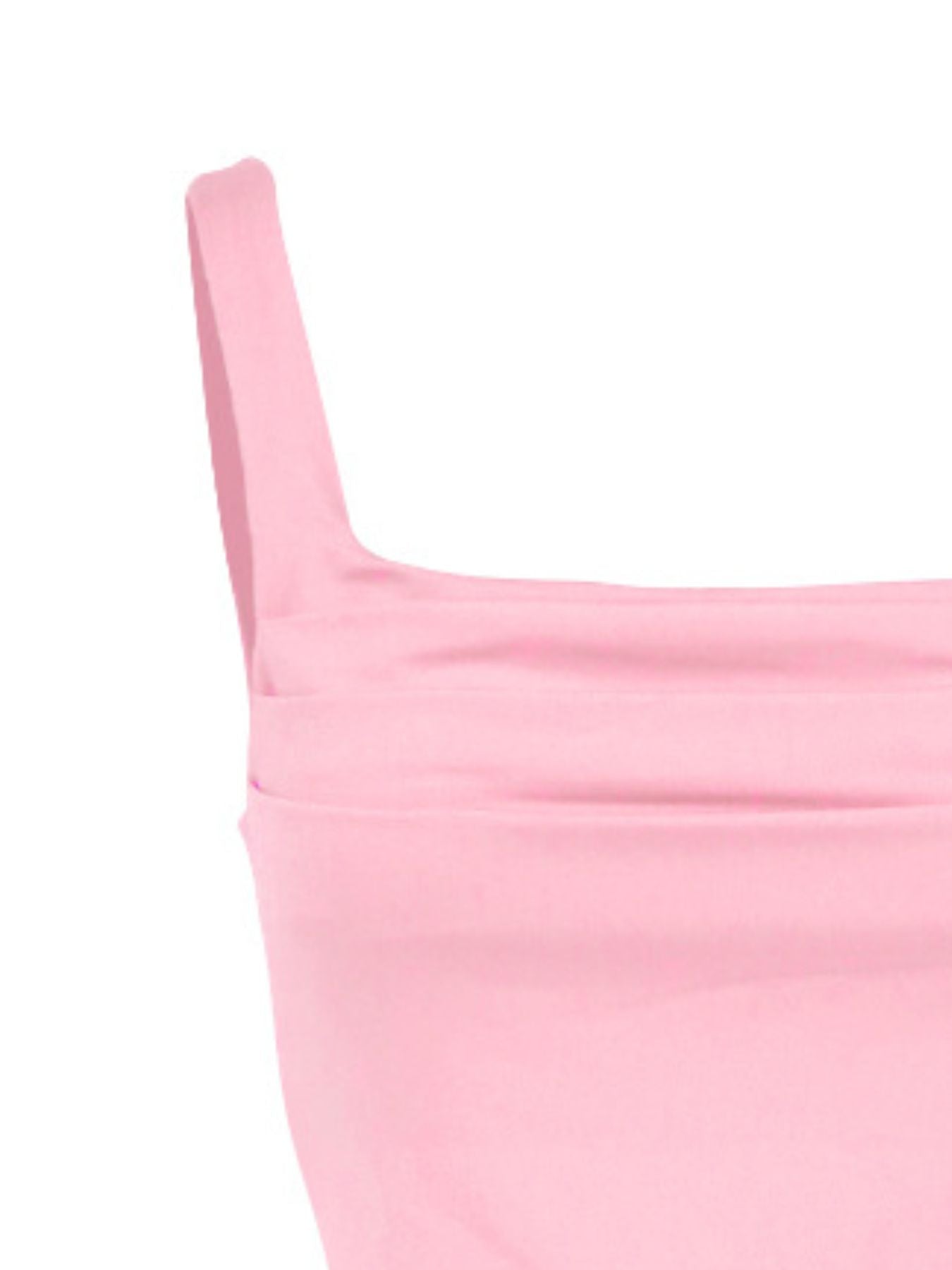 Close-up of a pink garment with thin straps on a white background