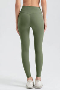 Green leggings worn by a person on a white background