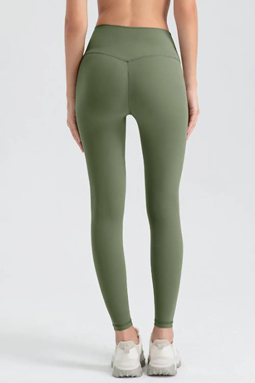 Green leggings worn by a person on a white background