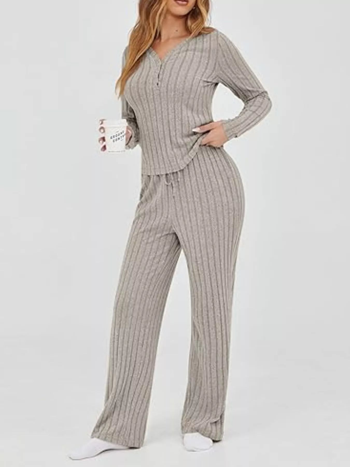 Woman wearing a gray ribbed lounge set on a white background