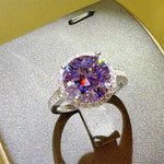 Ring with a purple gemstone on a textured surface