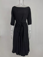 Black dress on a mannequin against a white background
