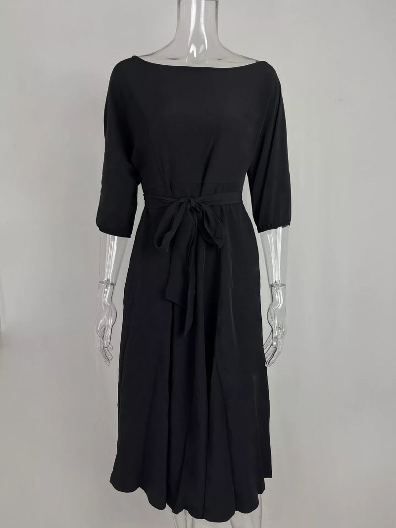 Black dress on a mannequin against a white background