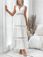Woman wearing a white lace dress in a bright room with white walls and wooden floor.