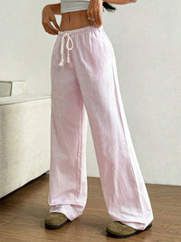 Person wearing pink striped pants with a white background