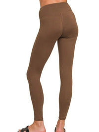 Brown leggings worn by a person on a white background