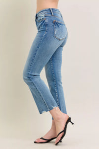 Light blue jeans worn by a person on a plain background