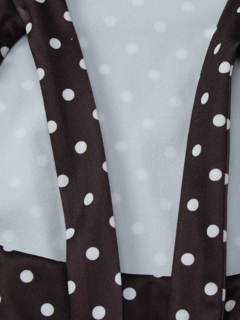Close-up of a brown fabric with white polka dots on a light gray background
