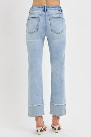 Light blue jeans worn by a person on a white background