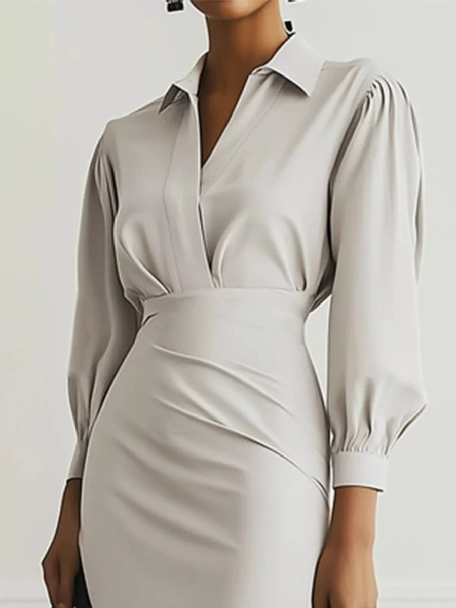 Beige dress with long sleeves on a plain background