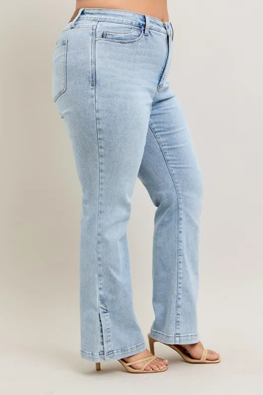 Light blue jeans worn by a person on a beige background