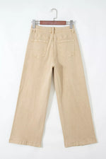 Beige pants on a hanger against a white background