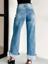 Blue jeans worn by a person on a white background
