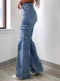 Person wearing blue wide-leg jeans in a minimal indoor setting