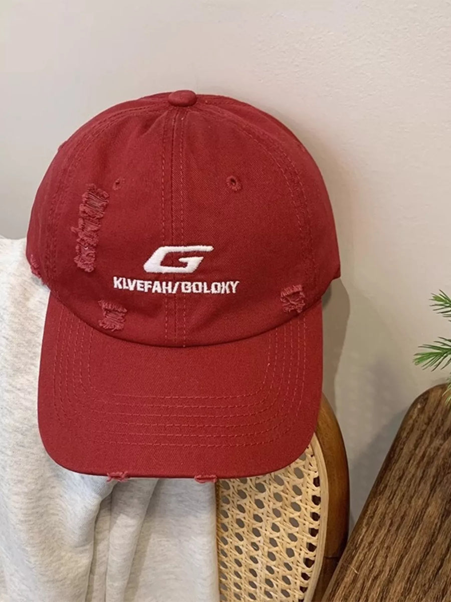 Red cap with a logo and text on a light background