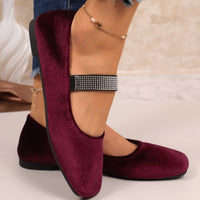 Burgundy loafers worn with a white background