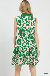 Green and white floral sleeveless dress on a model against a plain background