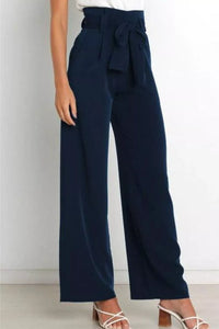 Navy blue wide-leg pants with a bow detail on a white background
