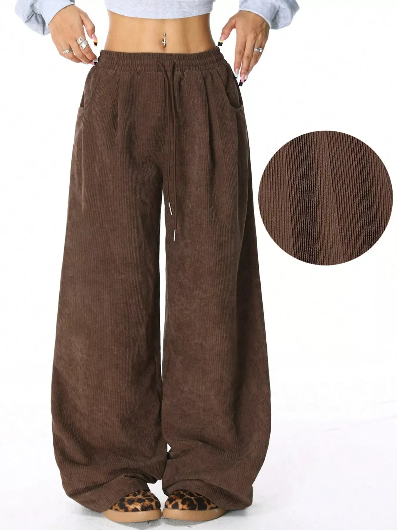 Brown wide-leg pants with a close-up of the fabric texture on a white background.
