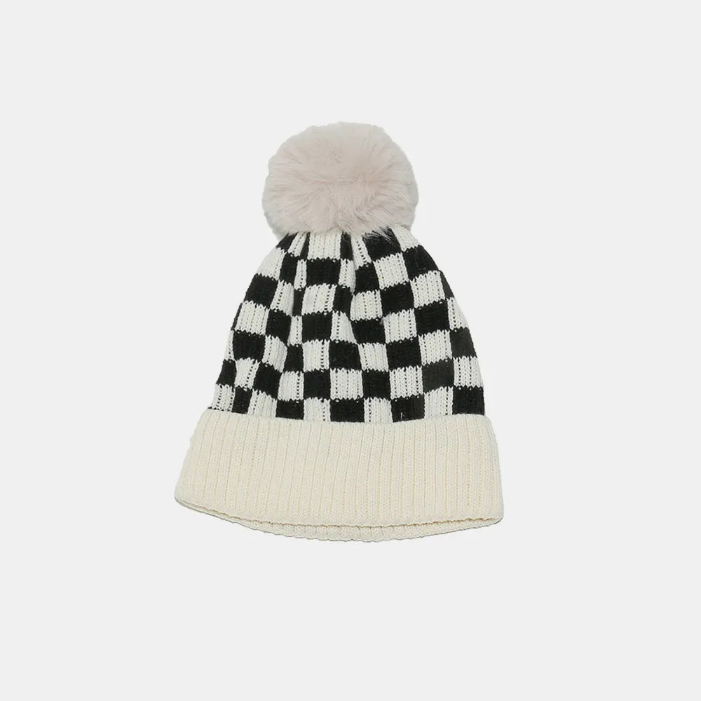 Checkered beanie with pom-pom on a white background