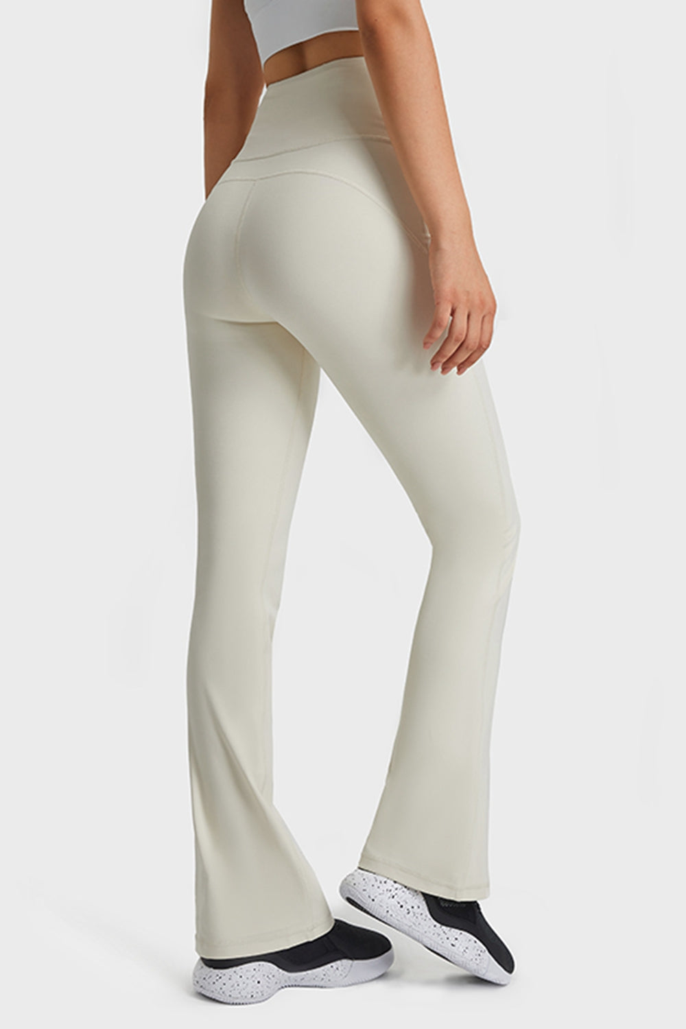 Person wearing light-colored pants on a white background