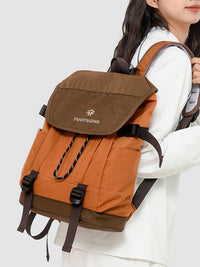Person wearing a brown and orange backpack with 'TUOTUZNE' branding on a white background
