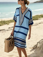 Woman on the beach wearing a blue dress